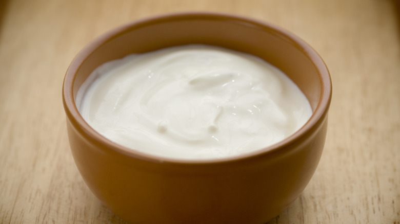 Sour cream in clay bowl