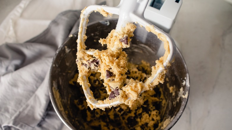 stand mixer attachment covered in cookie dough