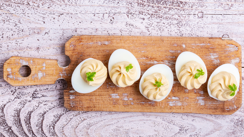 deviled eggs on a cutting board