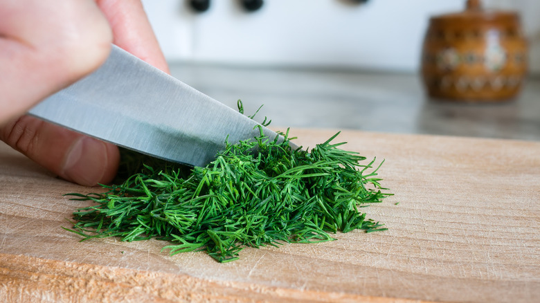 chef chopping fresh dill