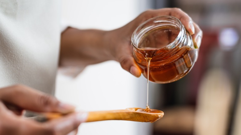 pouring honey onto spoon