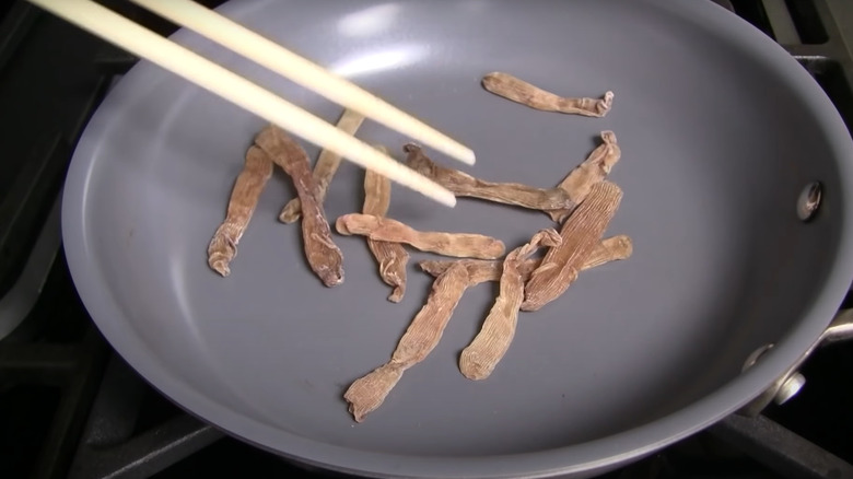 toasting dried sa sung in pan