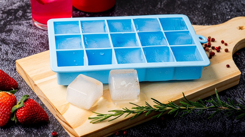 Ice cube tray on a brown cutting board