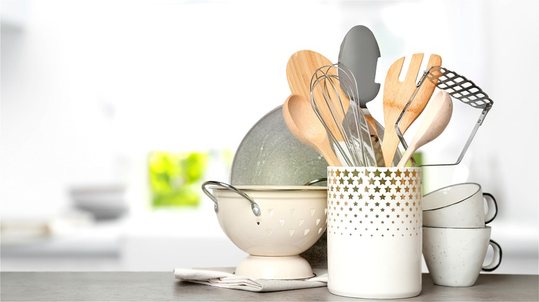 Kitchen utensils in star-covered crock 