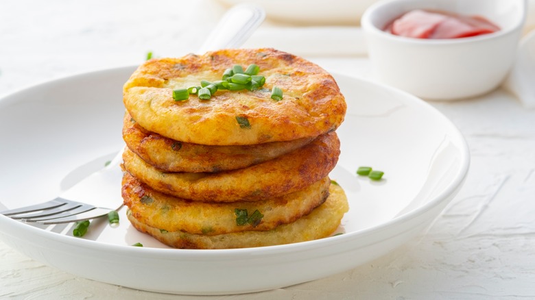 potato fritters stacked on plate