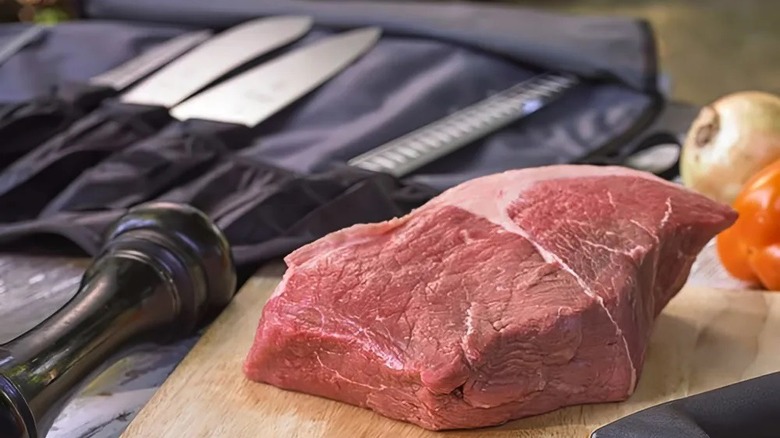 raw steak and barbecue tools