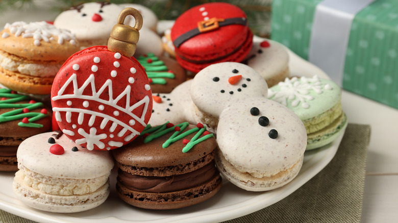 a variety of macarons in festive Christmas shapes and colors