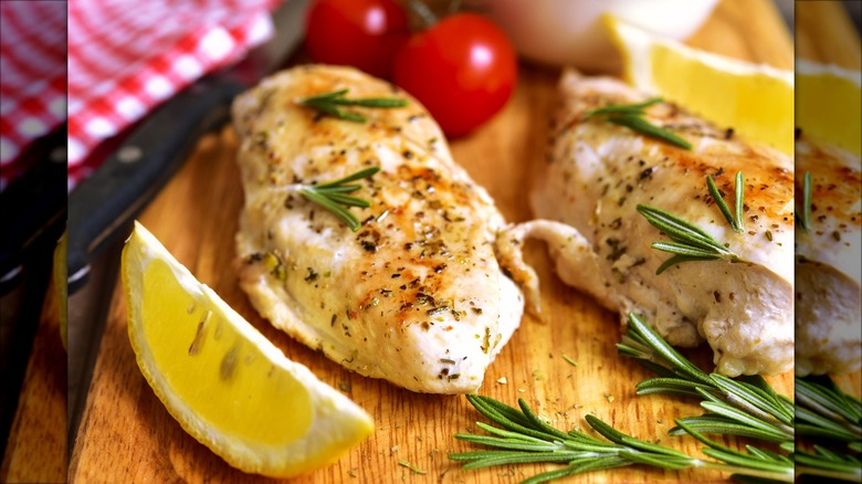 Person cutting raw chicken