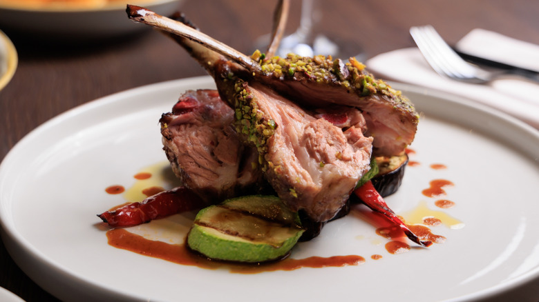 lamb chops on a plate at the dinner table