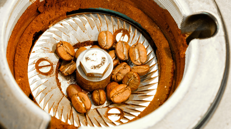 coffee beans and debris in grinder