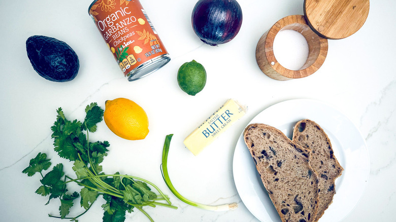 ingredients for chickpea avocado toast on marble counter