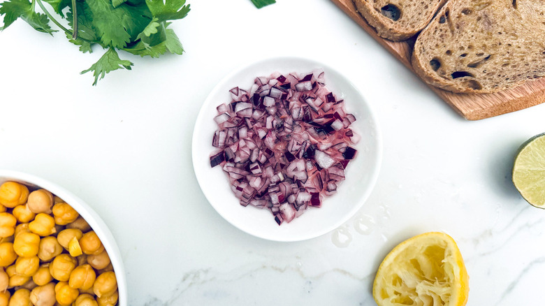 chopped red onions in white bowl