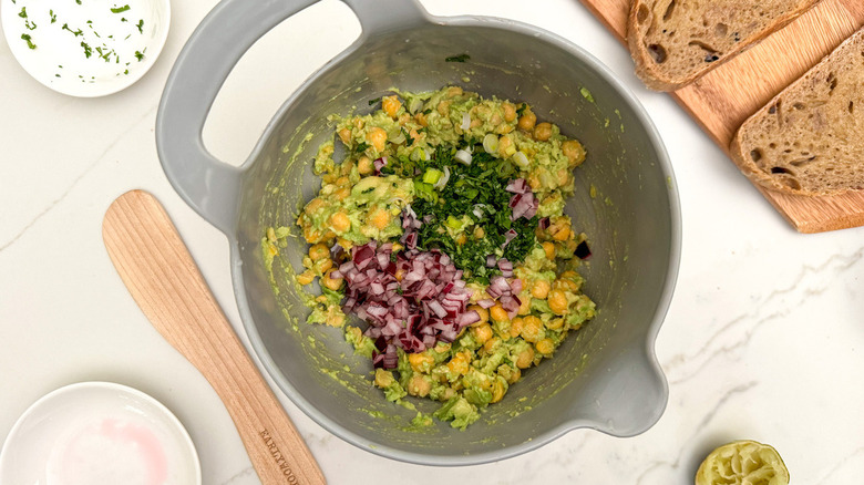 chickpeas avocado onion and seasonings in bowl